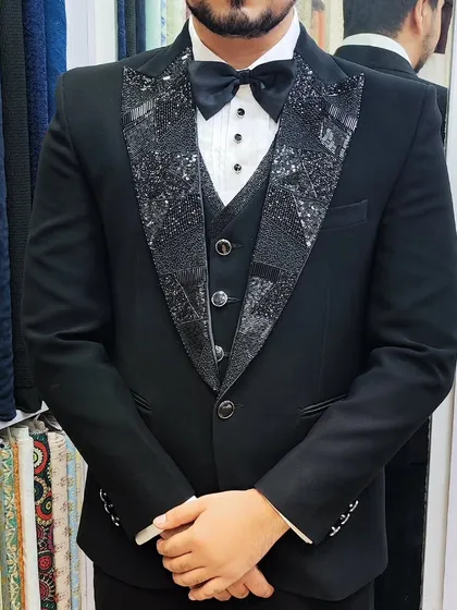 A collection of our designer suits, showcasing a variety of colors, fabrics, and custom details like embroidery, unique lapels, and accessories. Each piece is crafted to make a lasting impression.