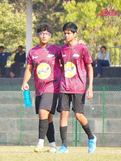 Two teammates walk off the field together, a simple moment showing the friendship and bonds formed at our academy.