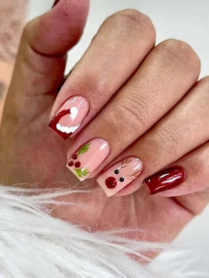 Red, glossy, and ready for Christmas. This cute and simple holiday set features a nude base with hand-painted reindeer, holly, and a Santa hat.