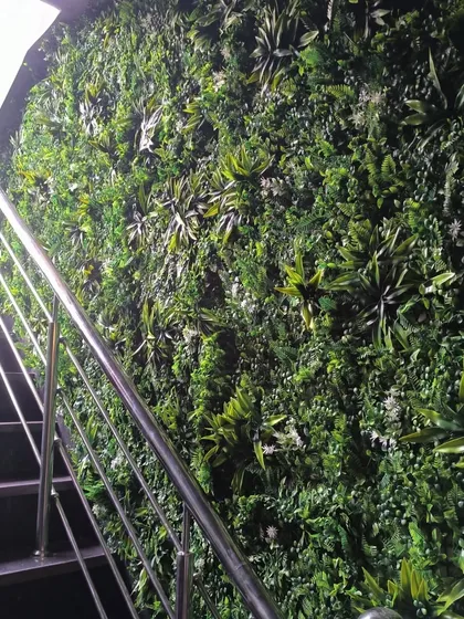 This shot shows the scale of the green mat installation at the Corfit gym entrance in Vikaspuri. It covers the entire wall along the staircase, creating a major visual impact.