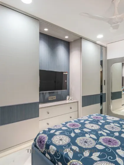 A view of the bedroom showcasing the sliding mirror wardrobe, which adds depth and reflects light, making the room feel more spacious.
