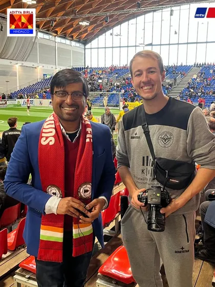 Connecting with the international football community. Mr. Gupta with a photographer at the MTU Cup, sharing our story with the world.