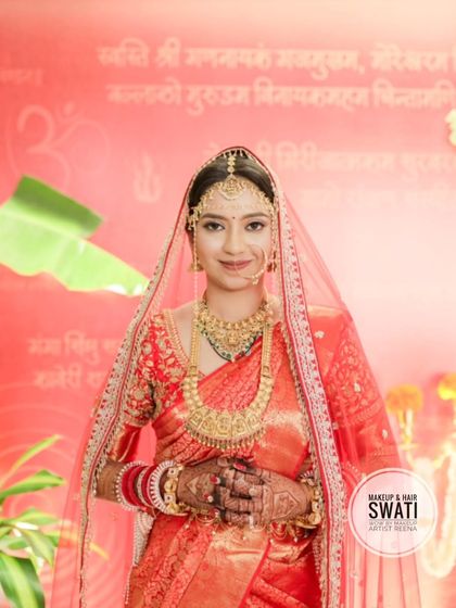 Kshitija looking serene under her wedding veil. The simple bindi and traditional jewellery complete her bridal look.