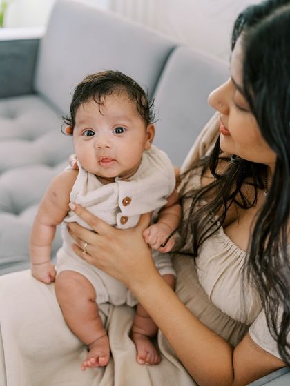 A mother holding her baby, both looking so content. These are the simple, loving moments that define the first year.