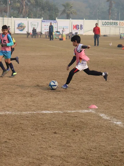 An action shot from the HCL league, showing a player mid-stride as he dribbles past a defender.