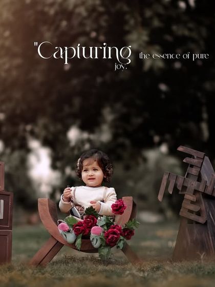 Capturing the essence of pure joy. A sweet little girl sits with her flowers and props during her outdoor first birthday session.