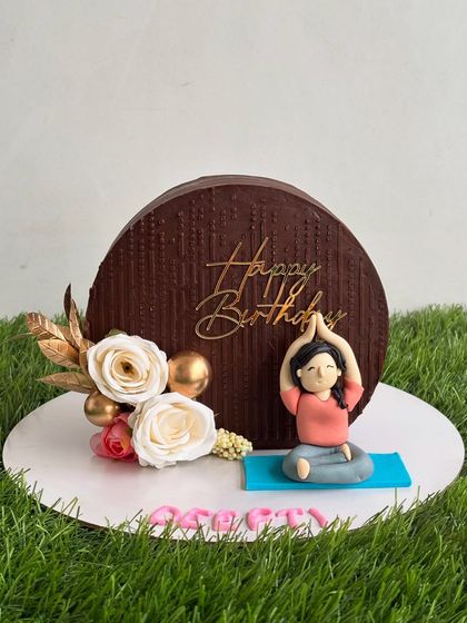 Another view of the yoga-themed cake top forward design, showing the beautiful details of the flowers and the personalized fondant figurine.
