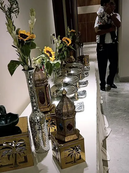 A stylish buffet setup for a housewarming party in DLF Phase 2. The Moroccan-style lanterns and modern decor elements add a sophisticated touch to the home environment.