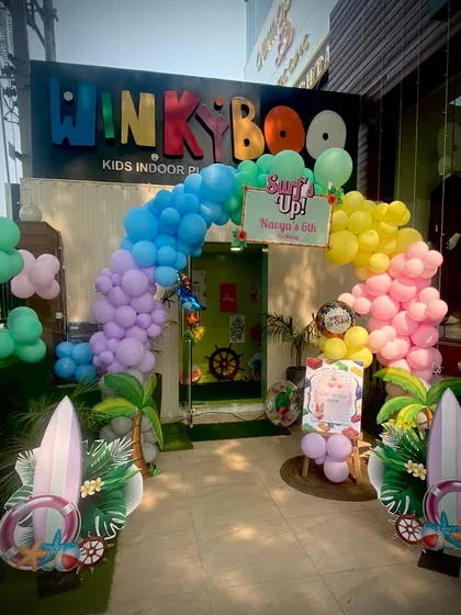 The party starts at the entrance! A colorful balloon arch and surfboard cutouts welcome guests to this fun-filled surf-themed birthday celebration.