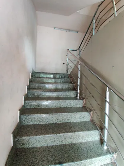 The staircase before its transformation, a simple and functional but uninspired part of the building.