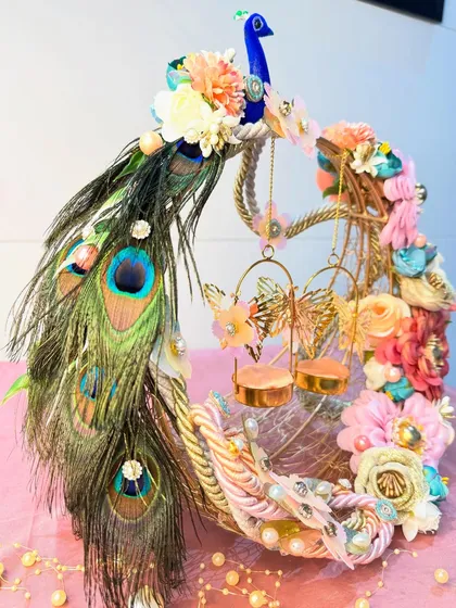 A beautiful variation of our peacock ring platter, this one features a cascade of pastel-colored flowers. The real peacock feathers and delicate butterfly ring holders add a touch of whimsical romance to the design.