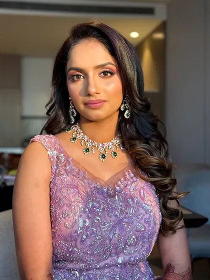 A close-up of the reception makeup, featuring a shimmery eyeshadow look and a flawless, glowing base.
