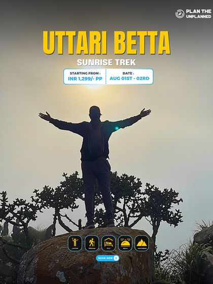 A trekker embraces the sunrise with open arms on the Uttari Betta sunrise trek.