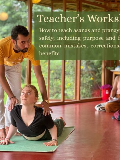In our teacher's workshop, we focus on the art of safe and effective teaching. A teacher guides a student through the nuances of Bhujangasana (Cobra Pose), explaining proper alignment and how to offer corrections.