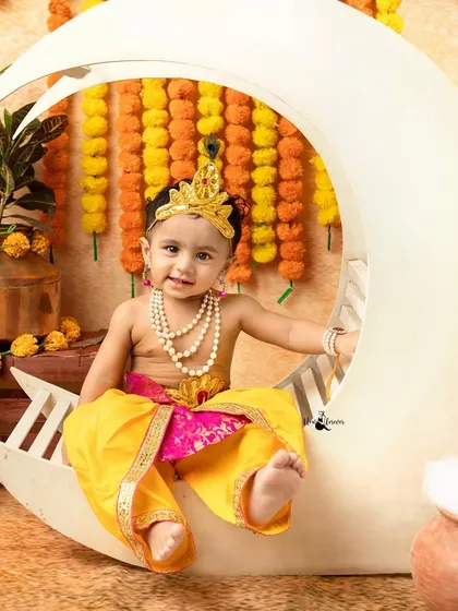 A sweet smile from a little Krishna sitting on the moon. This setup is one of our most popular for Janmashtami mini-sessions.