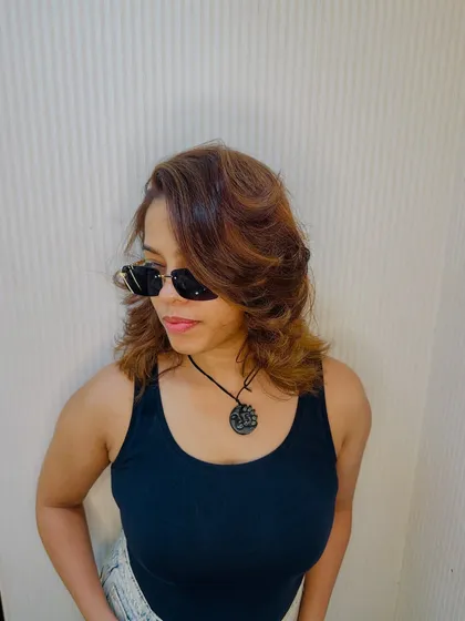 A cool, confident client rocking her new layered cut with sunglasses. It's a whole vibe.
