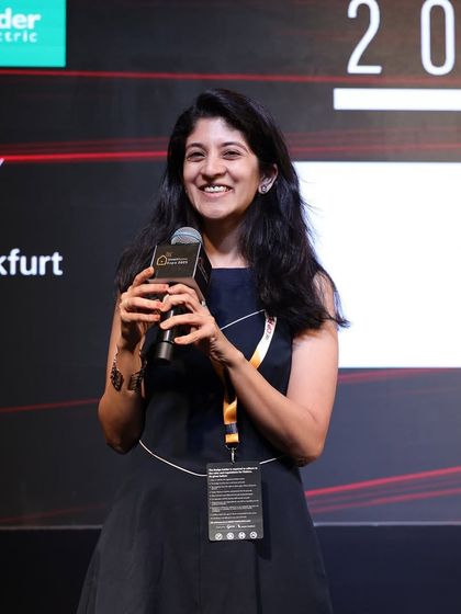 An award recipient gives her acceptance speech, sharing her excitement and gratitude on the Smart Space Awards stage.