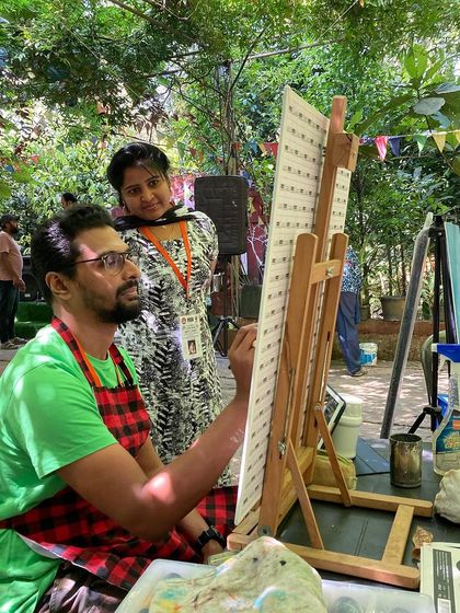 My wife watching as I work on a piece during the art camp. Her presence is always a great support.