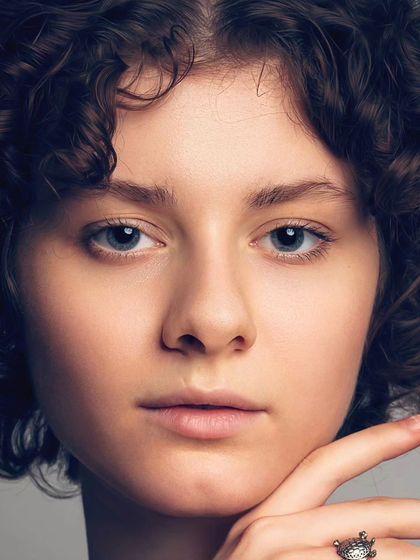 This is the raw, unedited close-up of a model's headshot. It shows the quality of the image straight from the camera, with sharp focus on the eyes and natural skin texture.