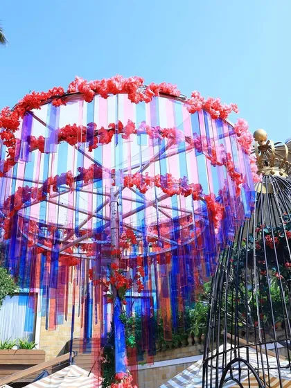 A creative and colorful overhead installation made of translucent ribbons, adding a playful and artistic touch to the Haldi decor.