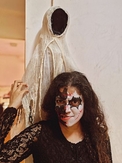 Getting into the Halloween spirit with some creative face paint and a spooky friend in the background. Our studio was fully decorated for the occasion.