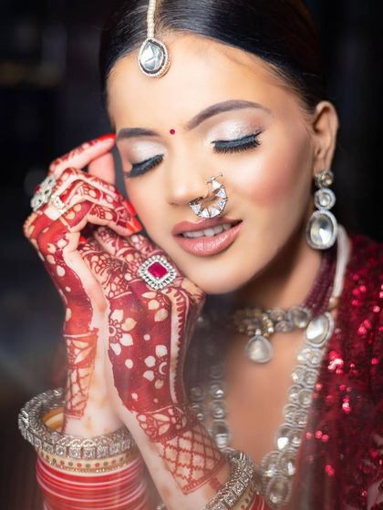 A beautiful candid shot of a bride with vitiligo, her eyes closed to showcase the stunning silver glitter eye makeup. This photo captures the flawless finish and the intricate details of her bridal look.
