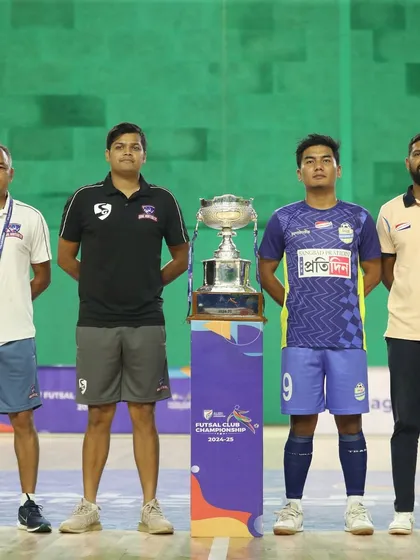 The captains and coaches of both finalist teams standing with the trophy before the match.