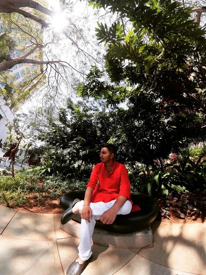 Taking a moment between sets at a daytime event. I believe in looking the part, and for traditional functions, a simple red kurta fits the festive mood perfectly.
