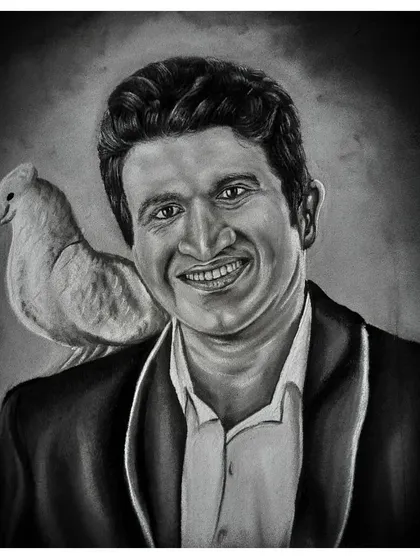 This full portrait of Puneeth Rajkumar includes the dove, a symbol of peace, and the 'Karnataka Ratna' title, making it a complete tribute piece. Each element is carefully rendered in charcoal.