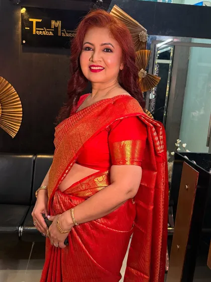 Another shot of the mom in her red saree, smiling and looking radiant.