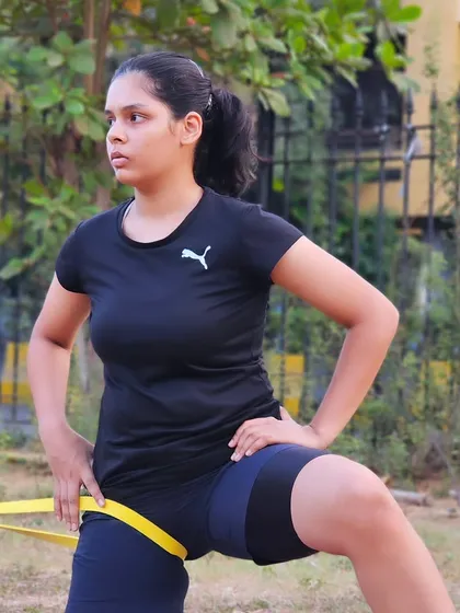 A player performs a resistance band lunge, focusing on control and stability through the movement.