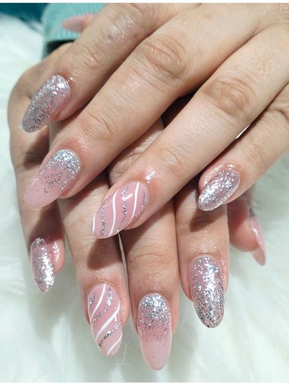 A beautiful pink and silver set, combining full-coverage silver glitter nails with sheer pink nails that have delicate white and silver stripes.