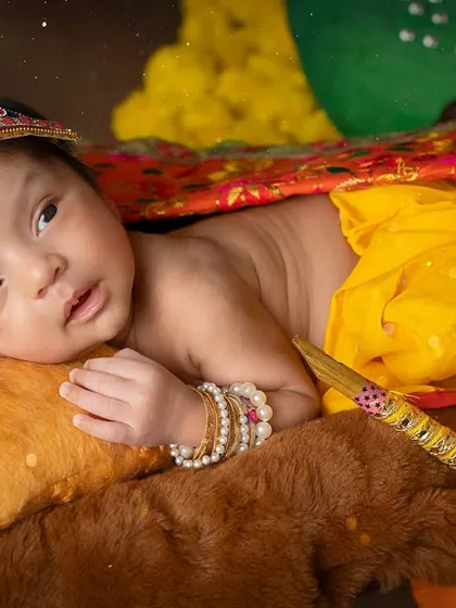 A close-up of our curious baby Krishna. His alert expression and the details of his crown make for a captivating portrait.