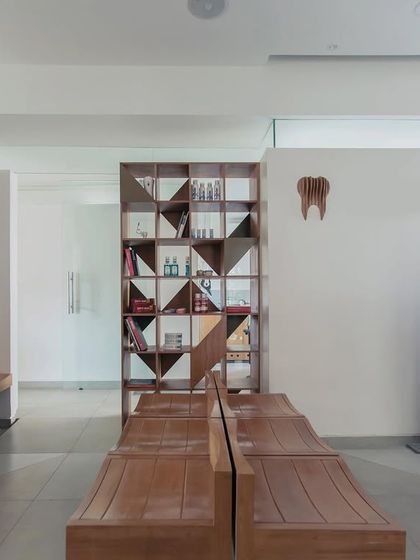 The waiting area of the Family Dental Care clinic. We used simple wooden benches and a geometric shelving unit to create a space that feels more like a calm lounge than a typical clinic waiting room.