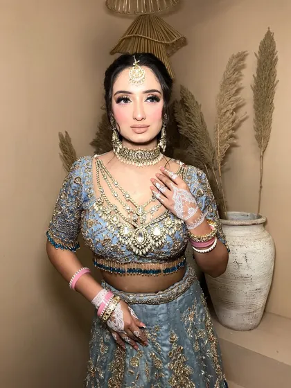 The styling of the layered kundan necklaces creates a rich, full neckline that is perfect for a bridal look.