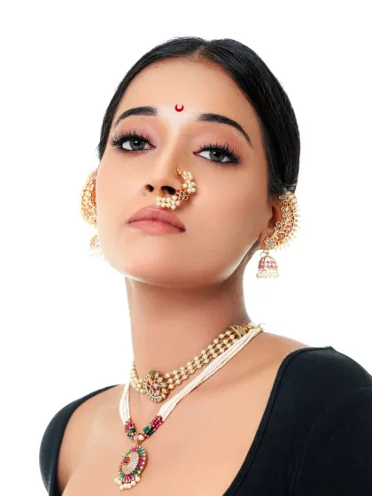 A powerful upward glance, showcasing the intricate details of the traditional nose ring and necklace. This is a classic shot for any ethnic jewelry campaign.