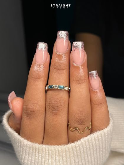 A close-up on the sparkling rose gold glitter tips. The effect is glamorous yet sophisticated.