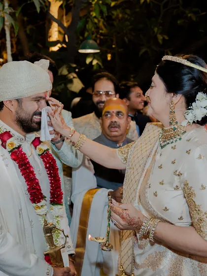 A touching moment as the mother of the groom wipes a tear from her son's eye. These are the memories that last a lifetime, and we are honored to style the family for them.