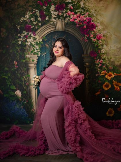 A confident and radiant pose from the mother-to-be, holding a bouquet in her beautiful ruffled gown.