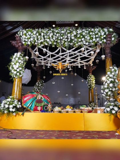 A wider view of the traditional bell mantap, showcasing the complete stage setup with ornate pillars and a decorated platform for the ceremony.