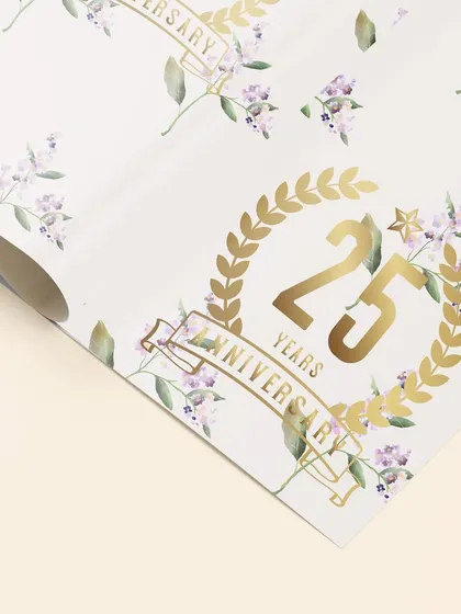 This detailed shot highlights the golden foil accents on the 25th anniversary wrapping paper. It is these small, high quality touches that elevate a design and make it feel truly special.