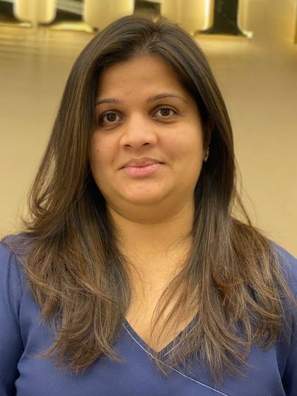 A client with freshly colored and styled hair. The subtle layers and even tone create a classic, polished look that is both healthy and beautiful.