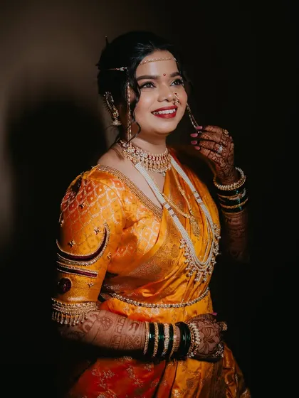 A stunning portrait highlighting the rich colors of the bride's attire and her radiant makeup.