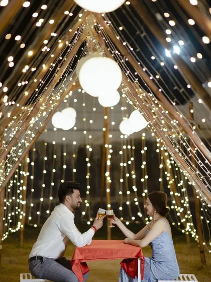 A candlelit dinner for two, surrounded by a tent of twinkling lights. This setup is the epitome of romance and makes for incredibly beautiful and intimate pre-wedding photos.