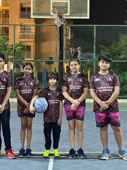 This is our uniform, this is our identity. My mixed-gender U-15 Warriors team stands united and ready for their next basketball match, showcasing their team pride.