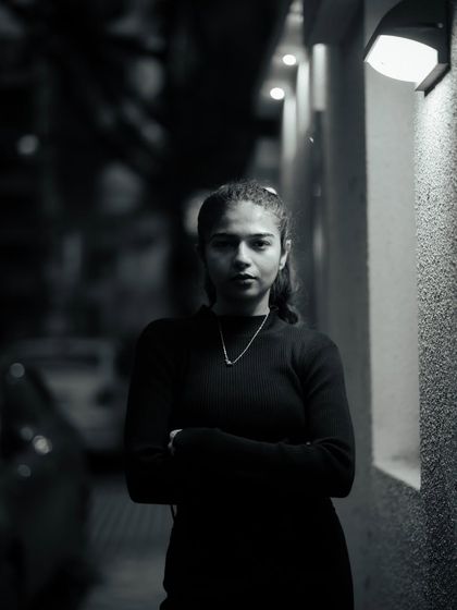 A dramatic black and white portrait using a single light source from the side. This technique creates strong shadows and a very moody, intense look.