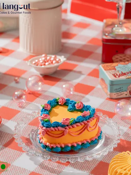 Our Vanilla Orange Bento Cake is a zesty and festive mini delight. The fluffy vanilla sponge is infused with a fresh orange twist and decorated with cheerful, colorful piping.