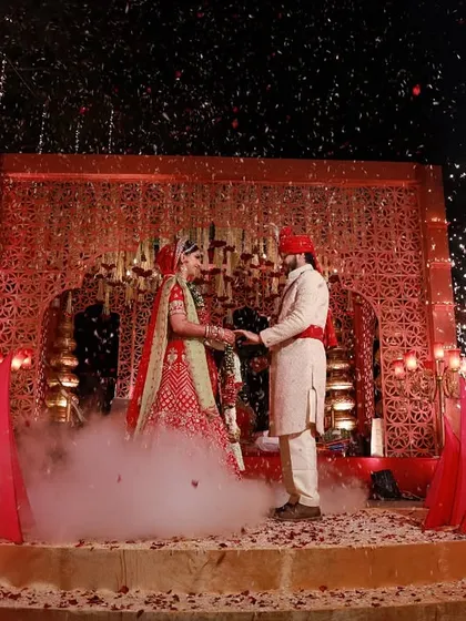 A moment of pure magic. I designed this opulent red and gold mandap to feel both royal and deeply romantic, with perfectly timed pyrotechnics to celebrate the couple's union under the stars.