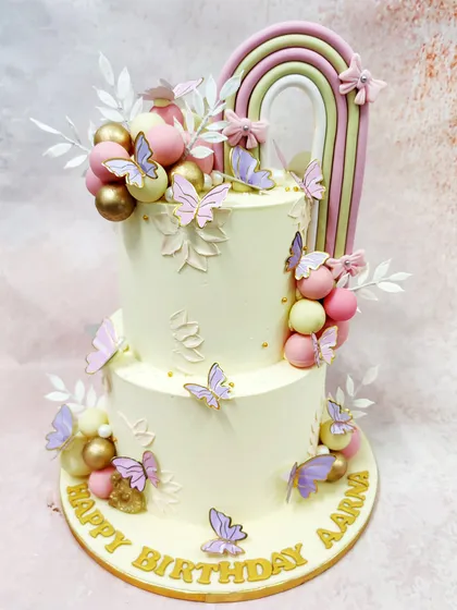 The full view of our Rainbow Butterfly Cake, a stunning two-tier creation that combines the beauty of rainbows and butterflies.