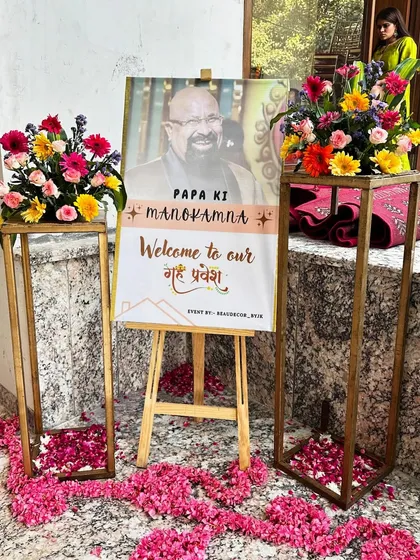 A personalized welcome sign for the Griha Pravesh, honoring the family's loved one. We surrounded it with fresh flowers and scattered petals to create a heartfelt entrance.